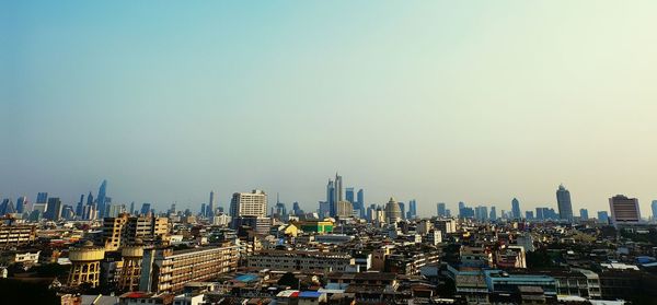 Modern buildings in city against clear sky