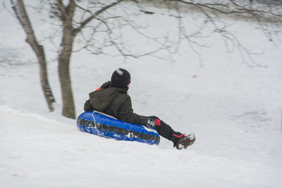 Rear view of girl on snow covered land