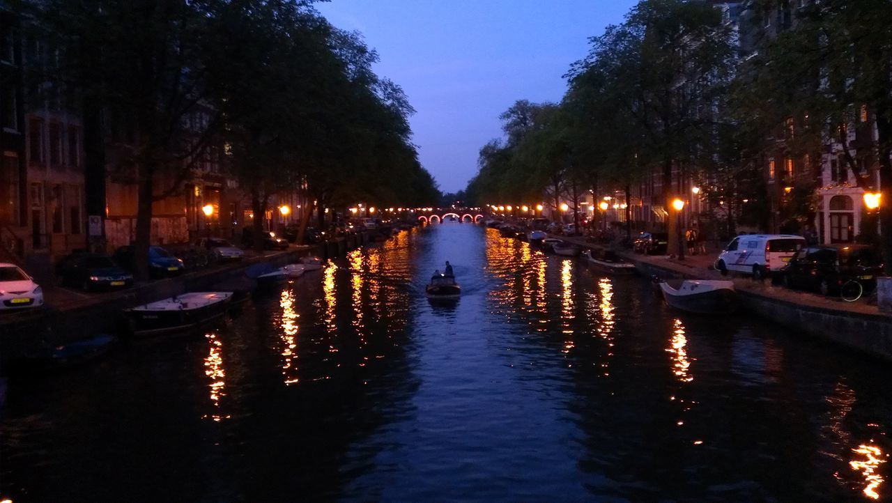 water, transportation, mode of transport, nautical vessel, reflection, moored, illuminated, boat, waterfront, canal, tree, street light, building exterior, in a row, river, city, built structure, outdoors, sunset, harbor