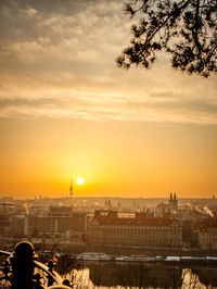 Prague tv tower at sunrise wirh roofs and birds flying