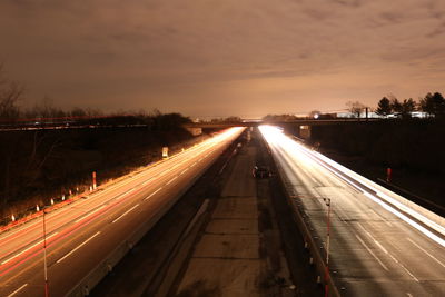 High angle view of light trails on highway at night