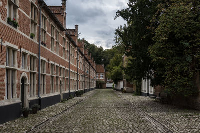 Street amidst buildings against sky