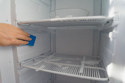 Defrosting.  a man wipes meltwater with a sponge. shallow depth of field. space for text.