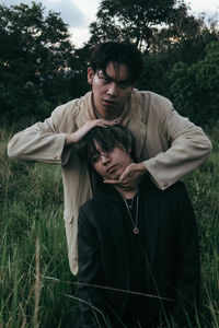 Young couple kissing on field