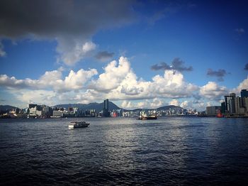 Sailboats in city at waterfront