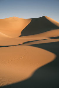 Scenic view of desert against clear sky