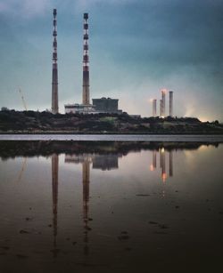 Reflection of illuminated tower in puddle