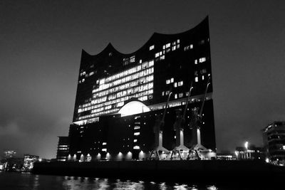 Low angle view of illuminated building against sky at night