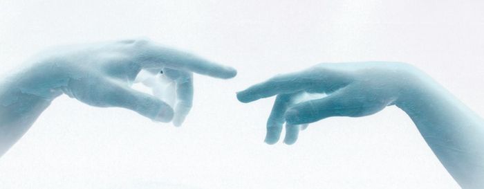 Close-up of hands over white background