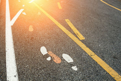 High angle view of arrow symbol on road in city