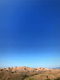 Scenic view of land against clear blue sky