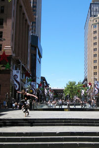 City street and buildings against sky