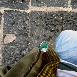 Low section of man standing on street