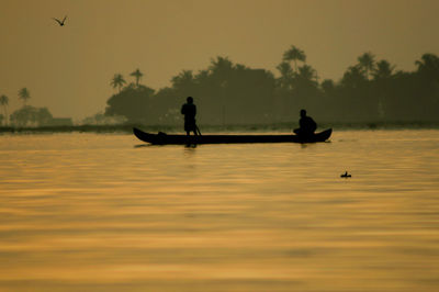 Boat in sea at sunset