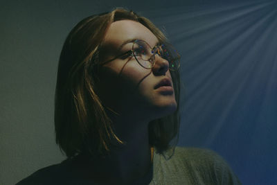 Close-up of thoughtful woman in eyeglasses