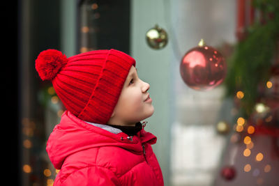 Side view of boy wearing knit hat outdoors