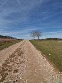 Dirt road along countryside landscape