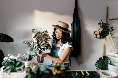 Woman holding flowers at home