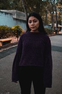 Portrait of woman standing in city