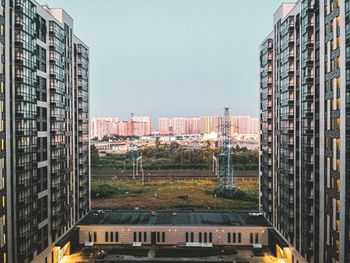 Buildings against clear sky seen through glass window