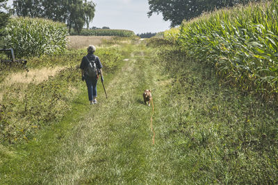 Woman walking the dog in field