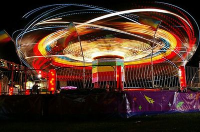 Illuminated ferris wheel at night