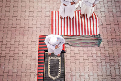 High angle view of people praying on footpath