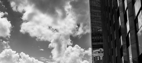 Low angle view of buildings against cloudy sky