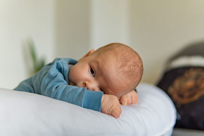 Baby resting on a pillow, young 1 month