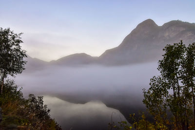 Scenic view of lake and mountains against sky