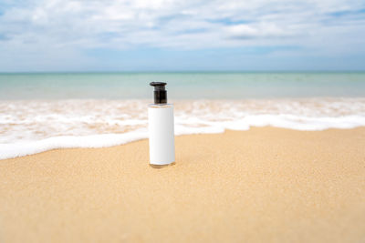 Bottle of products placed on the beach