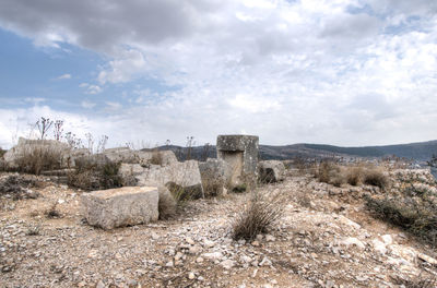 Old ruins on landscape against sky