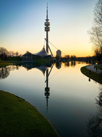 Reflection of tower in lake during sunset