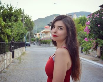 Portrait of beautiful woman against red mountain