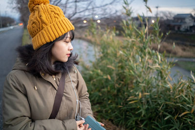 Young woman with eyes closed listening music