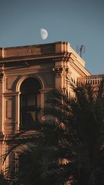 Low angle view of illuminated building against sky