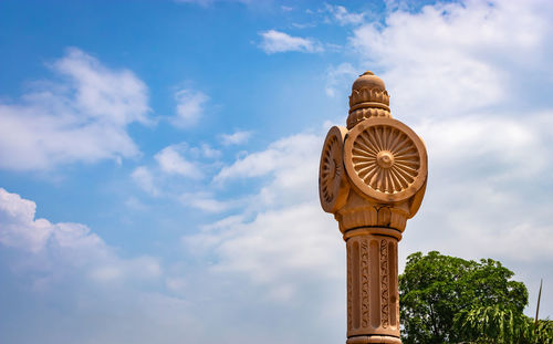 Artistic red stone jain god holy pillar with bright blue sky at morning from unique angle