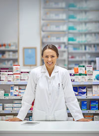 Portrait of pharmacist standing in store