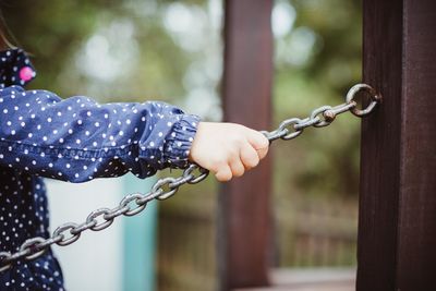 Close-up of hand holding chain