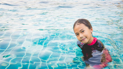 Portrait of smiling girl in swimming pool