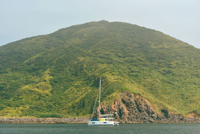 Scenic view of sea and mountains against sky