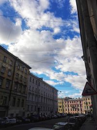 Street amidst buildings in city against sky