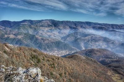 Scenic view of mountains against sky and city priboj