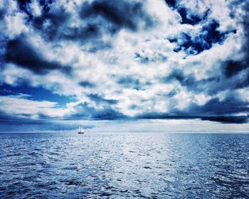 Scenic view of sea against cloudy sky