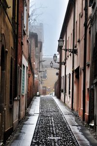 Road amidst city against sky