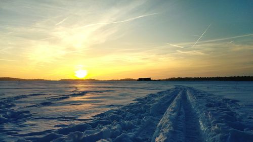 Scenic view of landscape against sky during winter