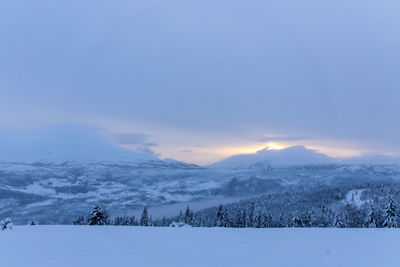 Scenic view of snowcapped mountains against sky during winter