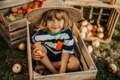 High angle view of cute baby girl sitting on field