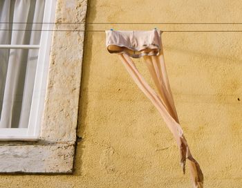 Low angle view of clothes hanging on wall