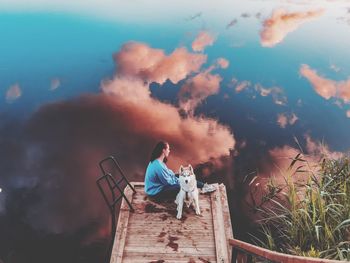 Rear view of man walking on mountain against sky